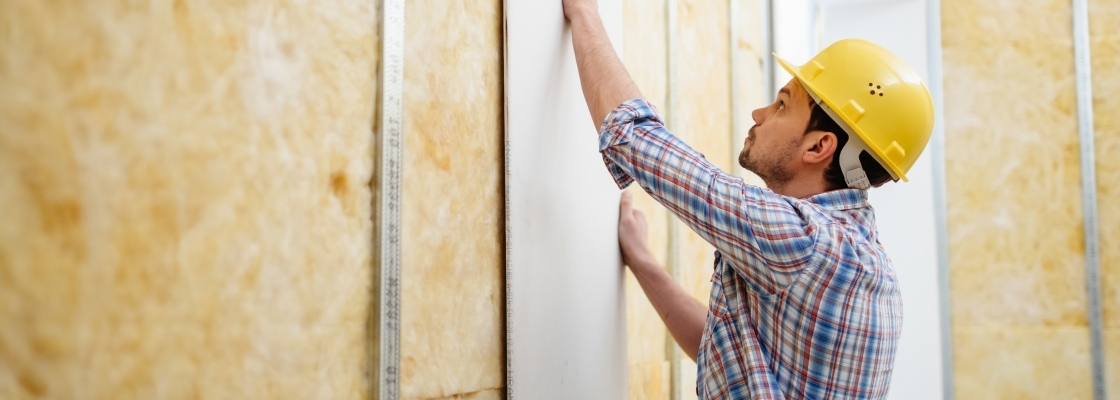 A home builder putting up drywall