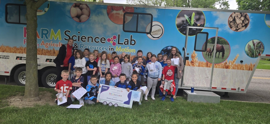 students in front of an agricultural trailer