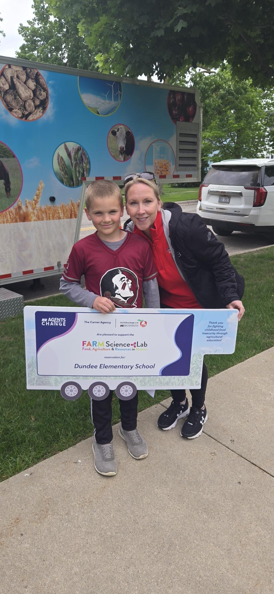 Jacey and Student with sign