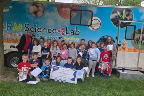 students in front of an agricultural trailer